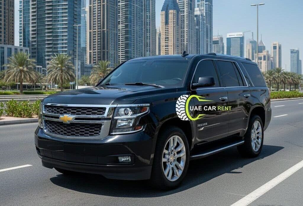 Chevrolet Suburban SUV car parked on a Dubai city road with modern skyscrapers in the background, featuring a black luxury full-size SUV used for car rental and chauffeur services in the UAE.