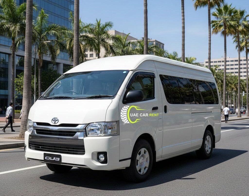 A high-resolution three-quarter front view of a white Toyota Hiace high-roof van parked on a sunny urban street lined with tall palm trees and modern glass buildings.